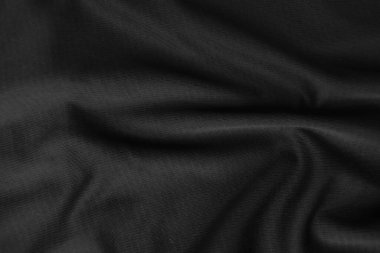 Arkaplan dokusu siyah kumaş. Soyut koyu dalgalı yumuşak. Kumaş kırışmış. Lüks moda tarzı..