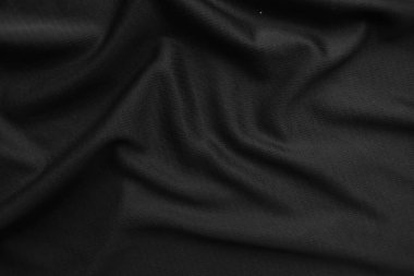 Arkaplan dokusu siyah kumaş. Soyut koyu dalgalı yumuşak. Kumaş kırışmış. Lüks moda tarzı..