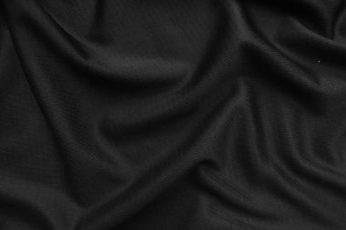 Arkaplan dokusu siyah kumaş. Soyut koyu dalgalı yumuşak. Kumaş kırışmış. Lüks moda tarzı..
