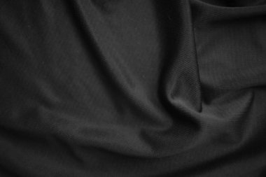 Arkaplan dokusu siyah kumaş. Soyut koyu dalgalı yumuşak. Kumaş kırışmış. Lüks moda tarzı..