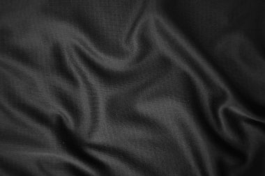 Arkaplan dokusu siyah kumaş. Soyut koyu dalgalı yumuşak. Kumaş kırışmış. Lüks moda tarzı..