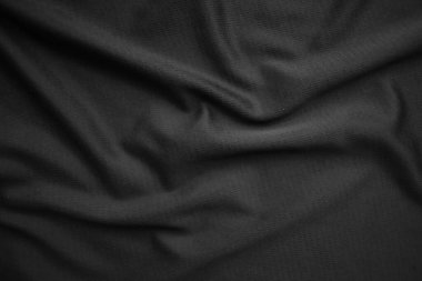 Arkaplan dokusu siyah kumaş. Soyut koyu dalgalı yumuşak. Kumaş kırışmış. Lüks moda tarzı..