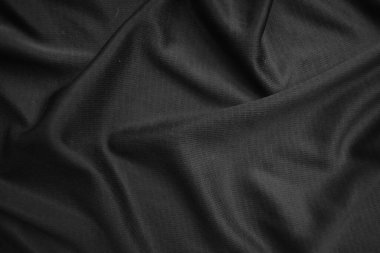Arkaplan dokusu siyah kumaş. Soyut koyu dalgalı yumuşak. Kumaş kırışmış. Lüks moda tarzı..