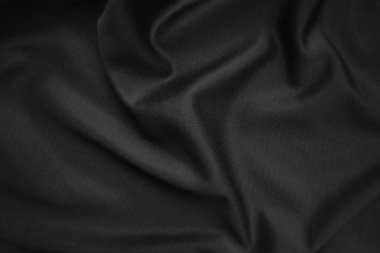 Arkaplan dokusu siyah kumaş. Soyut koyu dalgalı yumuşak. Kumaş kırışmış. Lüks moda tarzı..
