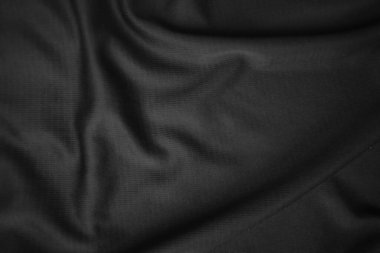Arkaplan dokusu siyah kumaş. Soyut koyu dalgalı yumuşak. Kumaş kırışmış. Lüks moda tarzı..