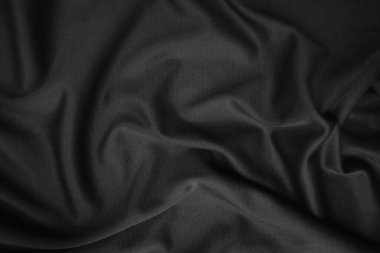 Arkaplan dokusu siyah kumaş. Soyut koyu dalgalı yumuşak. Kumaş kırışmış. Lüks moda tarzı..