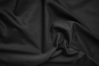Arkaplan dokusu siyah kumaş. Soyut koyu dalgalı yumuşak. Kumaş kırışmış. Lüks moda tarzı..