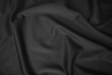 Arkaplan dokusu siyah kumaş. Soyut koyu dalgalı yumuşak. Kumaş kırışmış. Lüks moda tarzı..