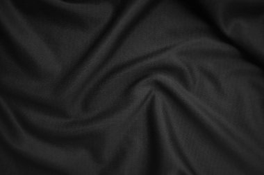 Arkaplan dokusu siyah kumaş. Soyut koyu dalgalı yumuşak. Kumaş kırışmış. Lüks moda tarzı..