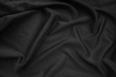 Arkaplan dokusu siyah kumaş. Soyut koyu dalgalı yumuşak. Kumaş kırışmış. Lüks moda tarzı..