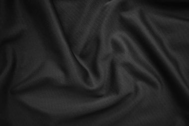 Arkaplan dokusu siyah kumaş. Soyut koyu dalgalı yumuşak. Kumaş kırışmış. Lüks moda tarzı..