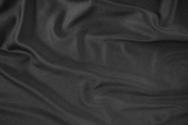 Arkaplan dokusu siyah kumaş. Soyut koyu dalgalı yumuşak. Kumaş kırışmış. Lüks moda tarzı..