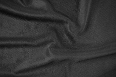 Arkaplan dokusu siyah kumaş. Soyut koyu dalgalı yumuşak. Kumaş kırışmış. Lüks moda tarzı..