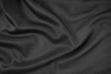 Arkaplan dokusu siyah kumaş. Soyut koyu dalgalı yumuşak. Kumaş kırışmış. Lüks moda tarzı..
