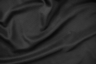 Arkaplan dokusu siyah kumaş. Soyut koyu dalgalı yumuşak. Kumaş kırışmış. Lüks moda tarzı..