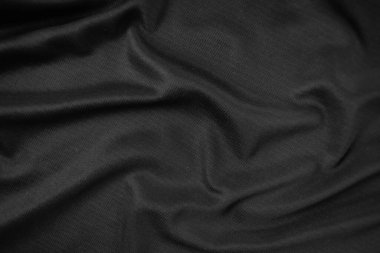 Arkaplan dokusu siyah kumaş. Soyut koyu dalgalı yumuşak. Kumaş kırışmış. Lüks moda tarzı..