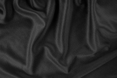 Arkaplan dokusu siyah kumaş. Soyut koyu dalgalı yumuşak. Kumaş kırışmış. Lüks moda tarzı..