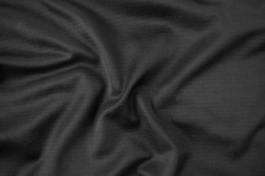 Arkaplan dokusu siyah kumaş. Soyut koyu dalgalı yumuşak. Kumaş kırışmış. Lüks moda tarzı..