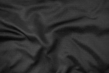 Arkaplan dokusu siyah kumaş. Soyut koyu dalgalı yumuşak. Kumaş kırışmış. Lüks moda tarzı..
