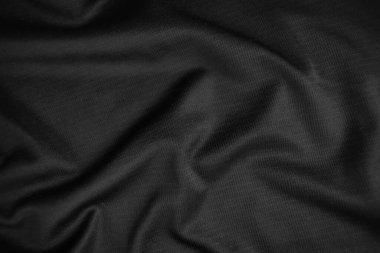 Arkaplan dokusu siyah kumaş. Soyut koyu dalgalı yumuşak. Kumaş kırışmış. Lüks moda tarzı..