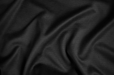 Arkaplan dokusu siyah kumaş. Soyut koyu dalgalı yumuşak. Kumaş kırışmış. Lüks moda tarzı..