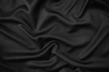 Arkaplan dokusu siyah kumaş. Soyut koyu dalgalı yumuşak. Kumaş kırışmış. Lüks moda tarzı..