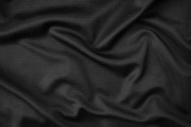 Arkaplan dokusu siyah kumaş. Soyut koyu dalgalı yumuşak. Kumaş kırışmış. Lüks moda tarzı..