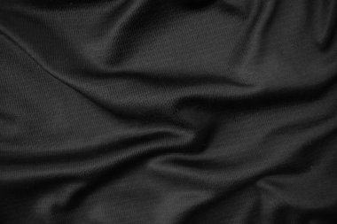 Arkaplan dokusu siyah kumaş. Soyut koyu dalgalı yumuşak. Kumaş kırışmış. Lüks moda tarzı..