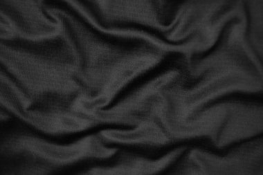 Arkaplan dokusu siyah kumaş. Soyut koyu dalgalı yumuşak. Kumaş kırışmış. Lüks moda tarzı..