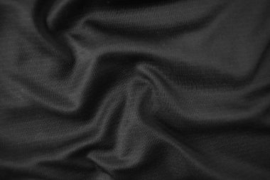 Arkaplan dokusu siyah kumaş. Soyut koyu dalgalı yumuşak. Kumaş kırışmış. Lüks moda tarzı..