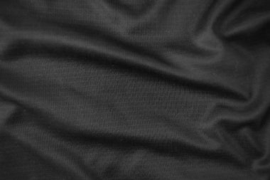 Arkaplan dokusu siyah kumaş. Soyut koyu dalgalı yumuşak. Kumaş kırışmış. Lüks moda tarzı..