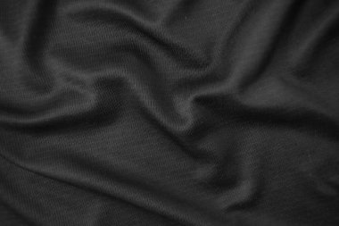 Arkaplan dokusu siyah kumaş. Soyut koyu dalgalı yumuşak. Kumaş kırışmış. Lüks moda tarzı..