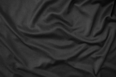 Arkaplan dokusu siyah kumaş. Soyut koyu dalgalı yumuşak. Kumaş kırışmış. Lüks moda tarzı..