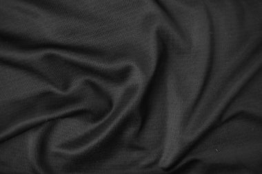 Arkaplan dokusu siyah kumaş. Soyut koyu dalgalı yumuşak. Kumaş kırışmış. Lüks moda tarzı..