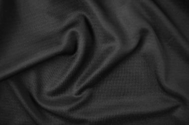 Arkaplan dokusu siyah kumaş. Soyut koyu dalgalı yumuşak. Kumaş kırışmış. Lüks moda tarzı..