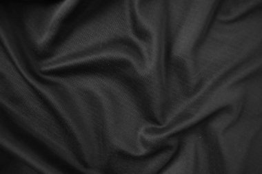 Arkaplan dokusu siyah kumaş. Soyut koyu dalgalı yumuşak. Kumaş kırışmış. Lüks moda tarzı..