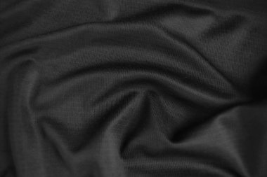 Arkaplan dokusu siyah kumaş. Soyut koyu dalgalı yumuşak. Kumaş kırışmış. Lüks moda tarzı..