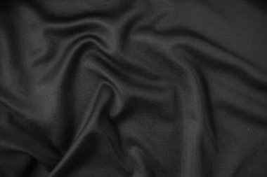 Arkaplan dokusu siyah kumaş. Soyut koyu dalgalı yumuşak. Kumaş kırışmış. Lüks moda tarzı..