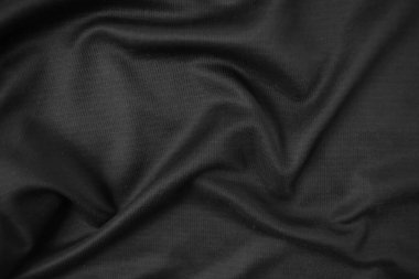 Arkaplan dokusu siyah kumaş. Soyut koyu dalgalı yumuşak. Kumaş kırışmış. Lüks moda tarzı..