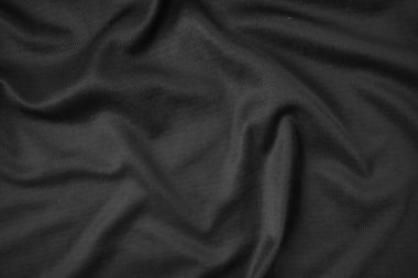 Arkaplan dokusu siyah kumaş. Soyut koyu dalgalı yumuşak. Kumaş kırışmış. Lüks moda tarzı..