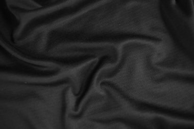 Arkaplan dokusu siyah kumaş. Soyut koyu dalgalı yumuşak. Kumaş kırışmış. Lüks moda tarzı..