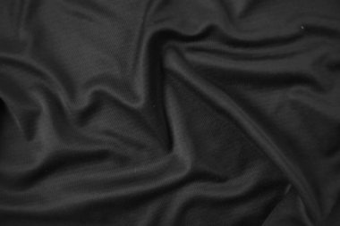 Arkaplan dokusu siyah kumaş. Soyut koyu dalgalı yumuşak. Kumaş kırışmış. Lüks moda tarzı..