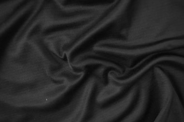 Arkaplan dokusu siyah kumaş. Soyut koyu dalgalı yumuşak. Kumaş kırışmış. Lüks moda tarzı..