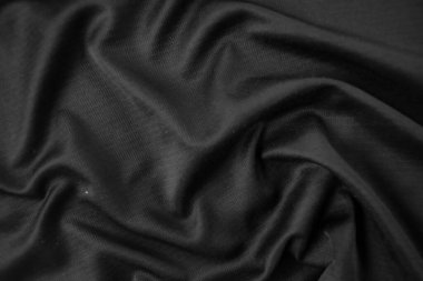 Arkaplan dokusu siyah kumaş. Soyut koyu dalgalı yumuşak. Kumaş kırışmış. Lüks moda tarzı..
