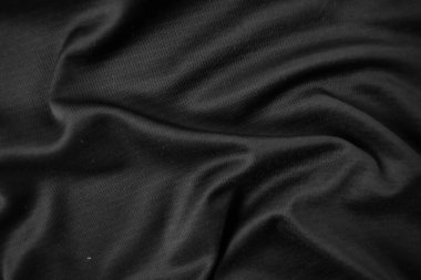 Arkaplan dokusu siyah kumaş. Soyut koyu dalgalı yumuşak. Kumaş kırışmış. Lüks moda tarzı..