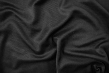 Arkaplan dokusu siyah kumaş. Soyut koyu dalgalı yumuşak. Kumaş kırışmış. Lüks moda tarzı..