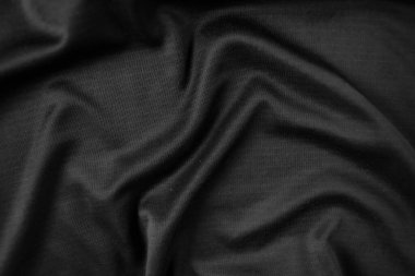 Arkaplan dokusu siyah kumaş. Soyut koyu dalgalı yumuşak. Kumaş kırışmış. Lüks moda tarzı..
