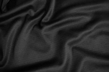 Arkaplan dokusu siyah kumaş. Soyut koyu dalgalı yumuşak. Kumaş kırışmış. Lüks moda tarzı..
