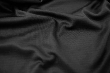 Arkaplan dokusu siyah kumaş. Soyut koyu dalgalı yumuşak. Kumaş kırışmış. Lüks moda tarzı..