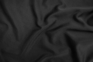 Arkaplan dokusu siyah kumaş. Soyut koyu dalgalı yumuşak. Kumaş kırışmış. Lüks moda tarzı..
